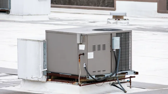 A packaged rooftop air conditioning unit on the flat roof of a commercial building